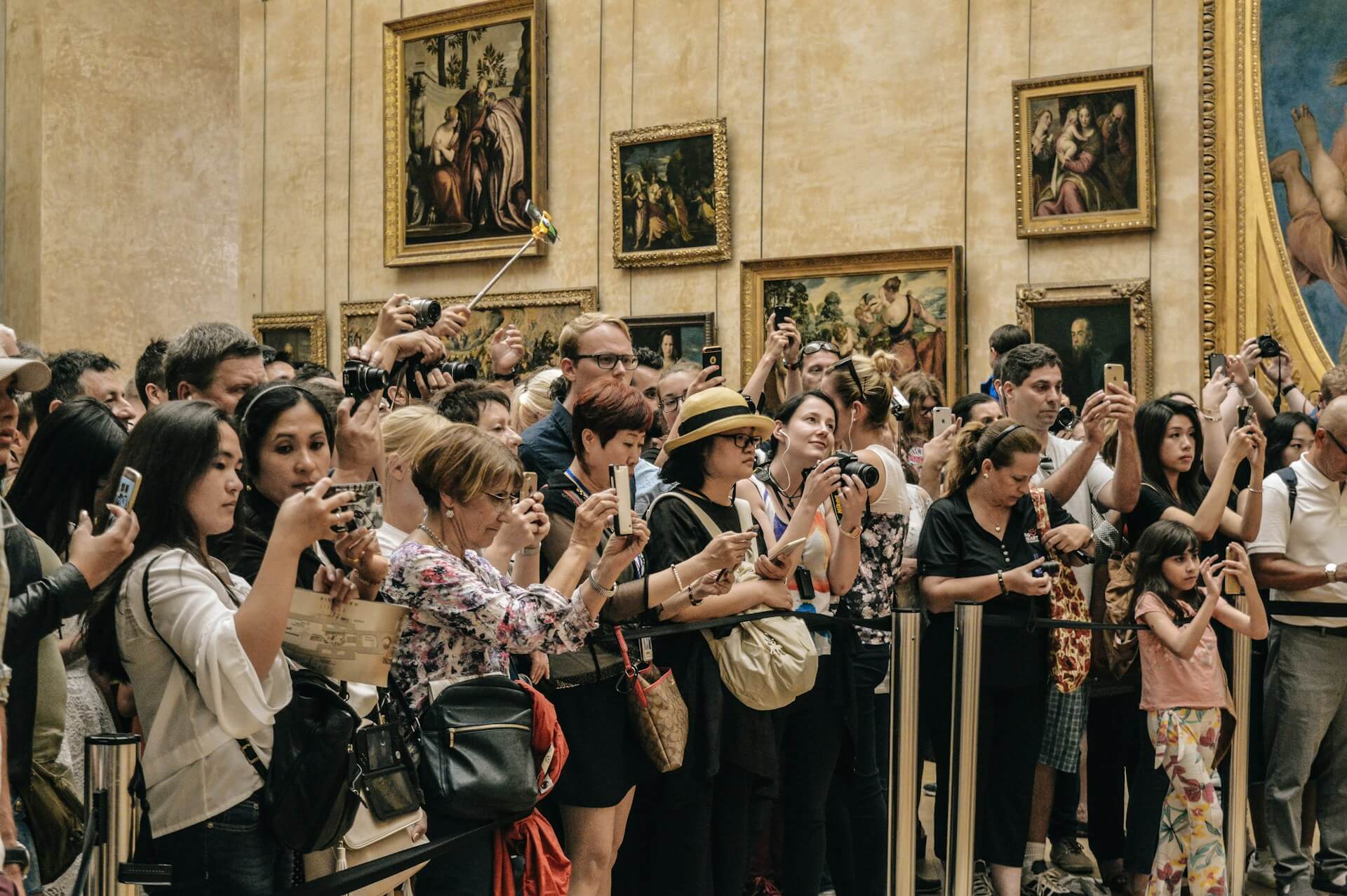 people taking photos of someone famous in a gallery